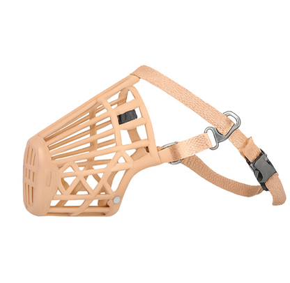 Beige dog muzzle with metal clips on a white background