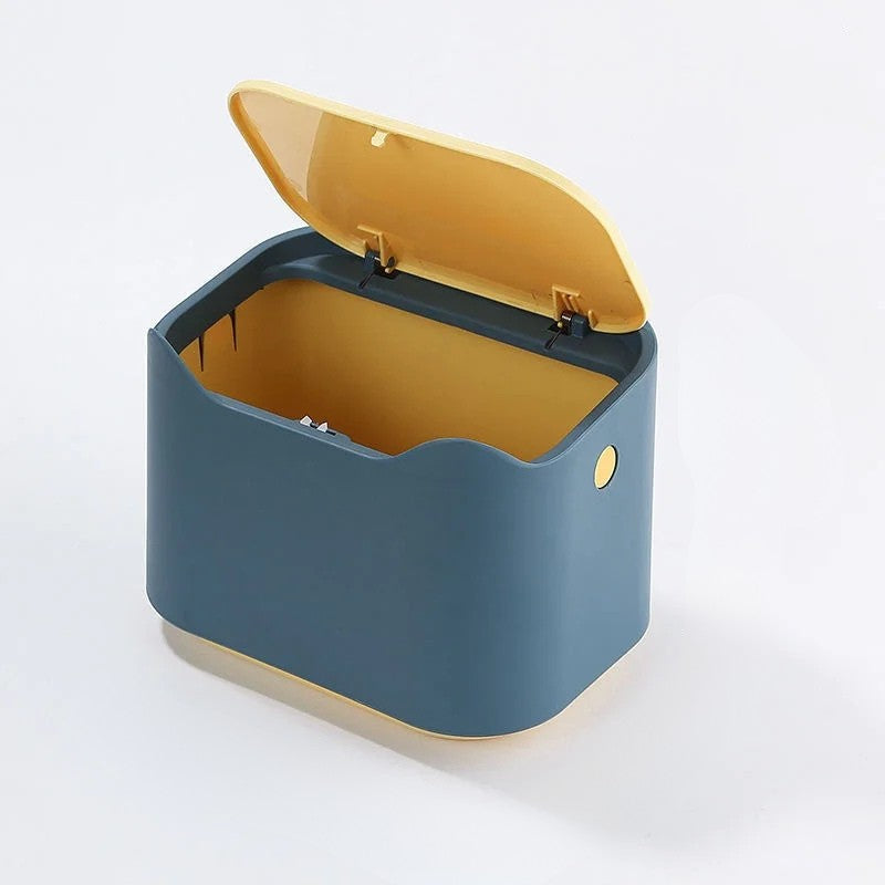 Blue and yellow trash bin on a white background